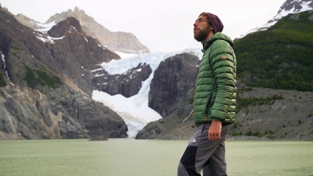 一名男子站在潘恩国家公园的冰川湖附近视频素材