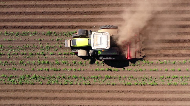 马铃薯田的农业机械在土地上耕作视频下载