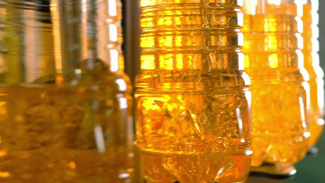 葵花籽油的瓶子在生产线上移动。视频下载