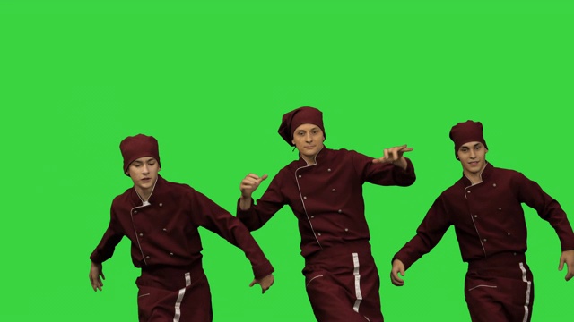 三个微笑的年轻厨师在绿色屏幕上跳舞，色度键视频下载