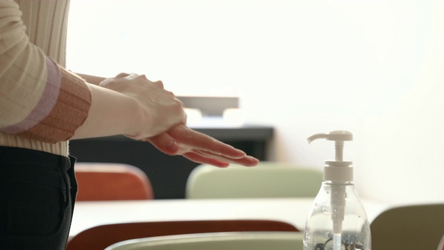 一名30多岁的韩国妇女在办公室用消毒液给双手消毒视频购买
