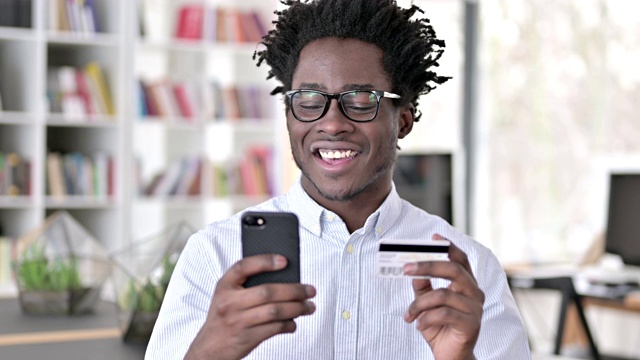 非洲男子用智能手机支付信用卡视频素材