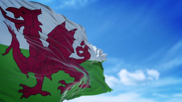 威尔士旗帜在4K分辨率的蓝天下缓缓飘扬视频下载