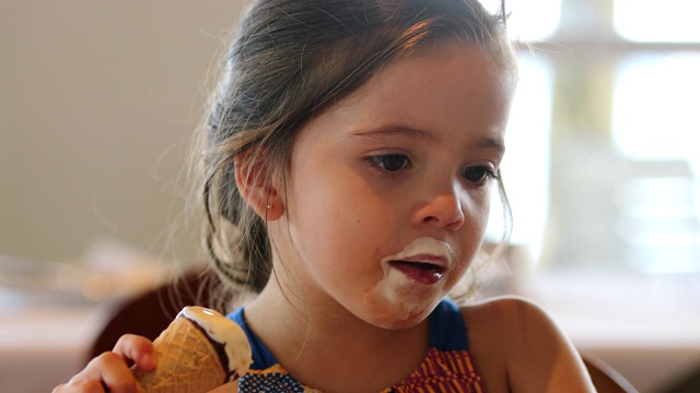 小女孩在吃蛋筒冰淇淋视频素材