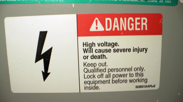 特写镜头的高压危险警告标志贴纸上的高压室内变压器从一个商业建筑安装视频下载