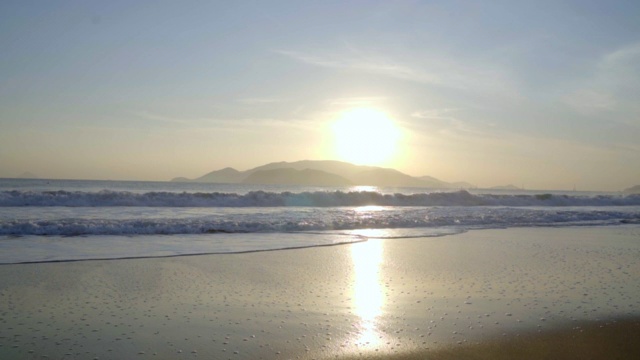 慢镜头:日出时的大海和海滩。视频素材