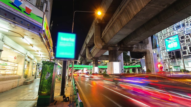 时间流逝，夜间交通长时间暴露在素坤逸路上在泰国曼谷巴通湾十字路口。视频下载