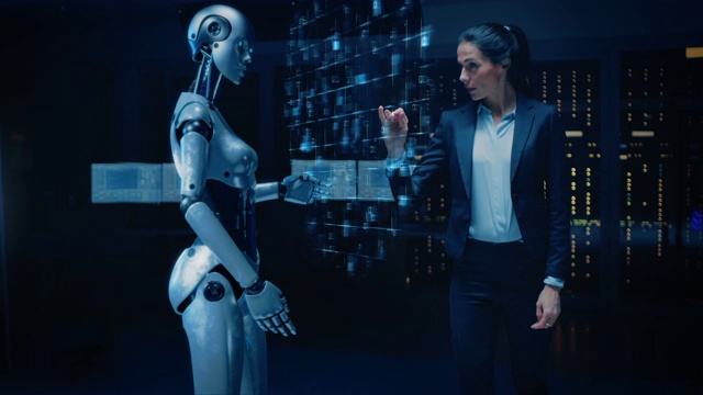 美丽，自信的女工程师触摸与人形机器人激活协作，团队协议。计算机人工智能概念:人与机器人协同工作视频下载