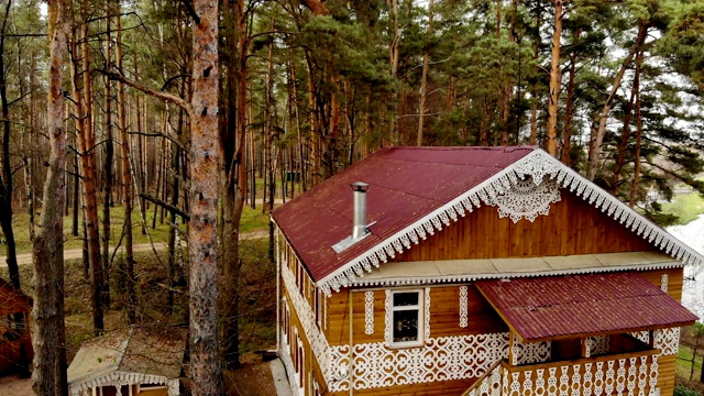 鸟瞰童话般的秋景，木雕小屋，松林。路房子在森林景观视频下载