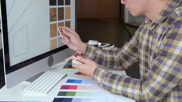 4K视频的人建筑师或设计师工作的颜色设计，家居改善和多任务在办公室视频素材