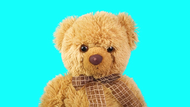 蓝色背景的泰迪熊。儿童玩具在运动。最喜欢的玩具视频下载
