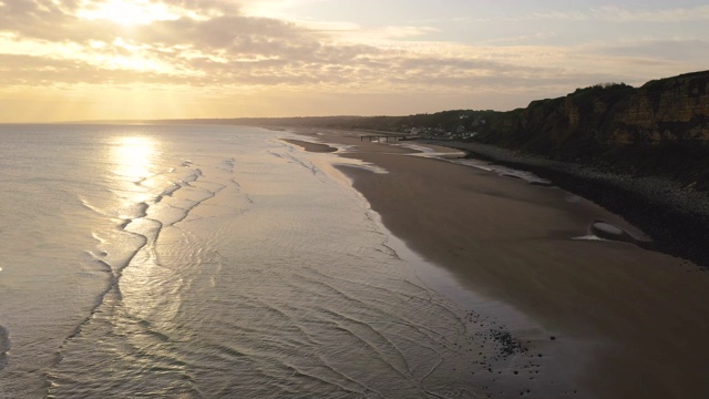 日出时，空中飞过法国奥马哈海滩的悬崖视频下载