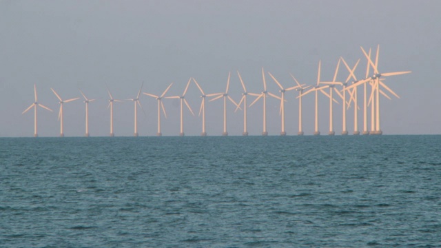 在晴朗的天空下，风力涡轮机在海上的封锁镜头——丹麦哥本哈根视频素材