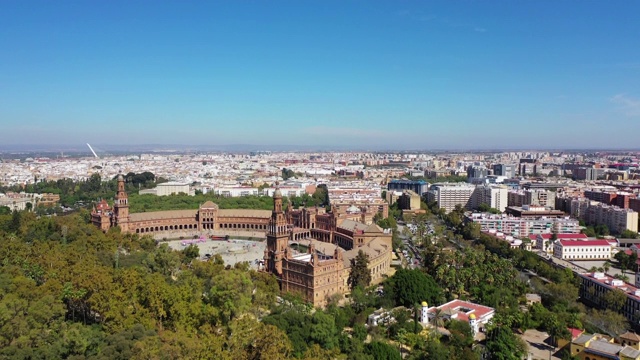 晴空下的西班牙广场航拍，无人机在西班牙塞维利亚的绿树上空视频素材