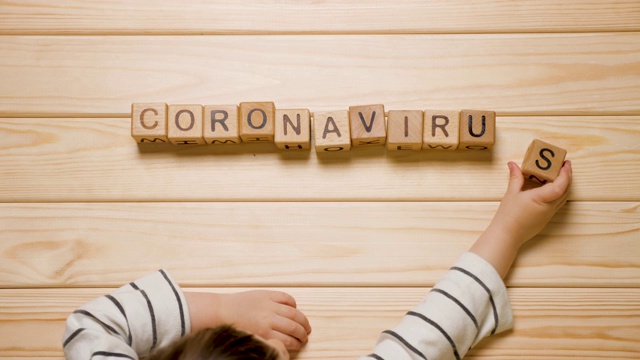 儿童和冠状病毒。COVID-19背景。儿童心理学。孩子们用手列出冠状病毒的单词。流行病、流行病和儿童。隔离，孩子在家。家庭学校。nCOV-2概念视频素材