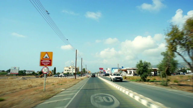 在塞浦路斯帕福斯，阳光明媚的日子里，在城市的道路上拍摄的车辆视频素材
