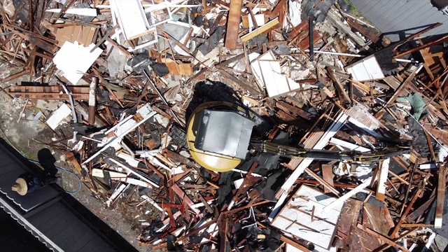 无人机的视图直接在上面旋转向下看房屋拆迁和被挖掘机破坏的新房子建设。视频素材