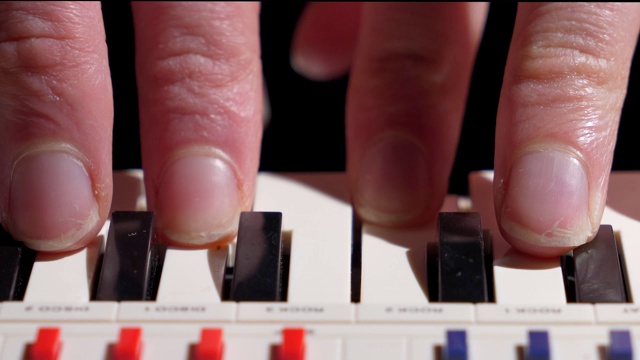 宏手指弹奏迷你钢琴键盘视频素材