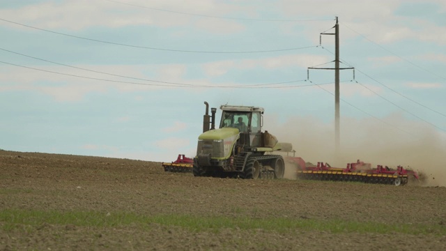 近距离射击。一台拖拉机正在耕地。4 k视频素材