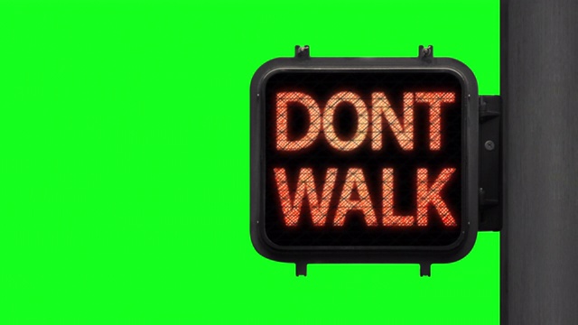 绿屏色度键拍摄，显示行人行走信号的近景，从行走的身影到不行走的身影视频素材