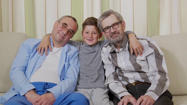 两个爷爷和一个孙子坐在沙发上。视频下载