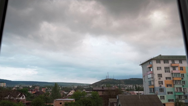 云朵迅速地飞过窗外的城市和山视频下载