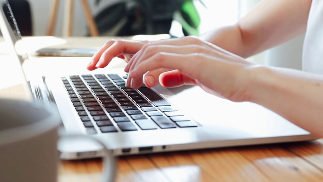 特写，侧面的女人在电脑键盘上打字视频素材