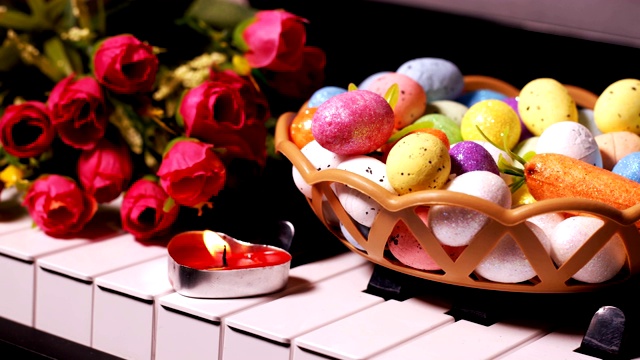 复活节彩蛋，钢琴琴键上的鲜花和蜡烛视频素材