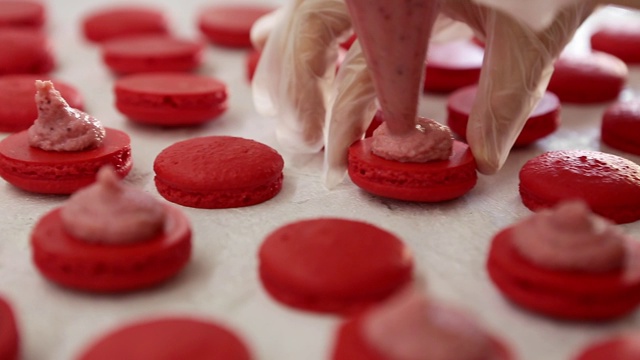 制作马卡龙的过程马卡龙，法式甜点，挤压面团形成烹饪袋视频素材
