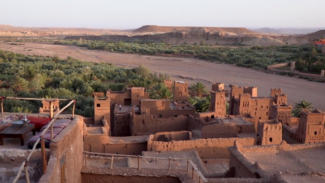 从古城堡ksar Ait Ben Haddou顶部鸟瞰图与粘土房子山谷与绿色，摩洛哥附近的瓦尔扎扎特在阿特拉斯山脉。视频素材