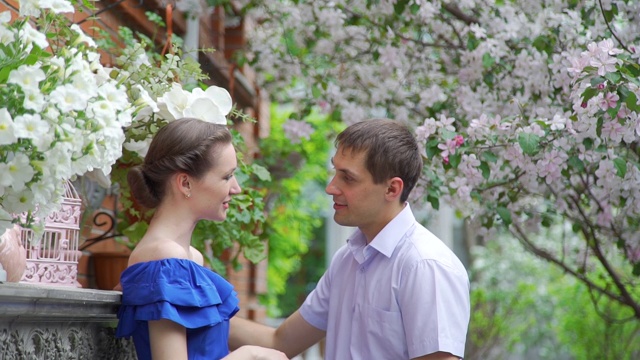 美丽的夫妇在春天的鲜花盛开的花园视频下载