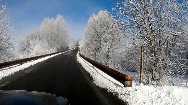 在冬季下雪的时候，在空旷的道路上驾驶的风景与被雪覆盖的景观视频素材