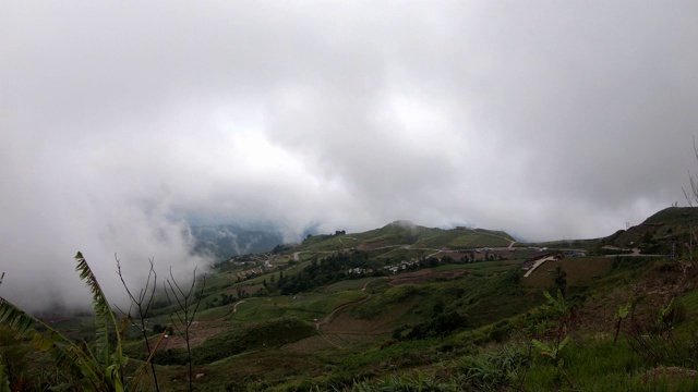 时间流逝的运动云朵在天空中快速移动在白天明亮的和公路上的汽车行驶在山上在泰国，碧差汶。视频下载