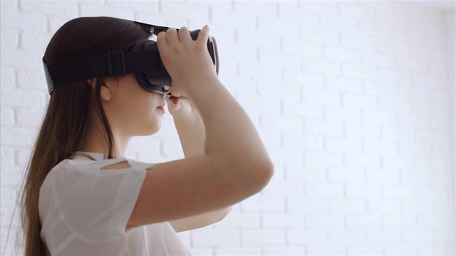 年轻女子用现代虚拟现实眼镜触摸东西，4k视频素材