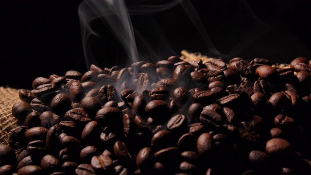 微距拍摄黑咖啡豆与烟视频下载