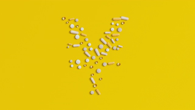 日元符号形状的白色药丸在黄色的背景视频素材