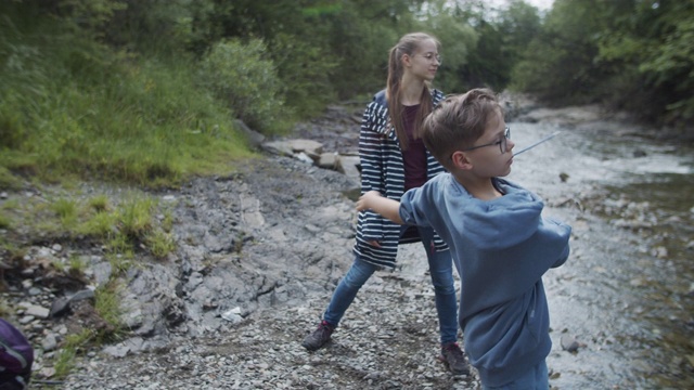 哥哥和妹妹喜欢在河上打石子视频素材