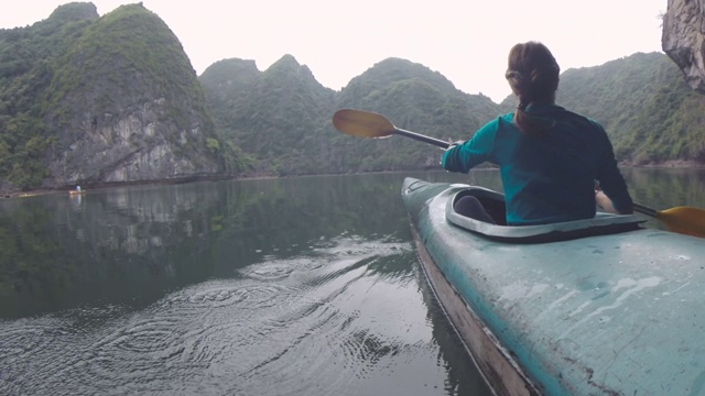 女子划着皮划艇，探索越南下龙湾视频素材