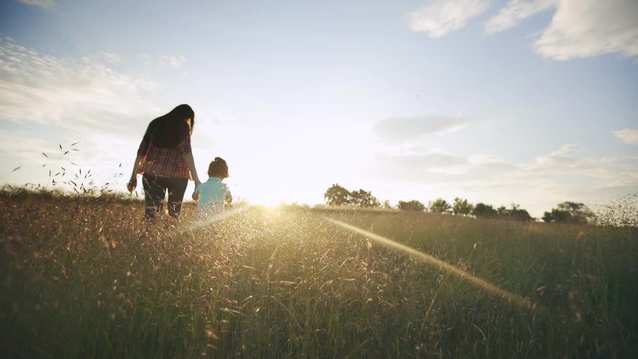 日落时分，妈妈带着孩子在大自然中散步视频下载
