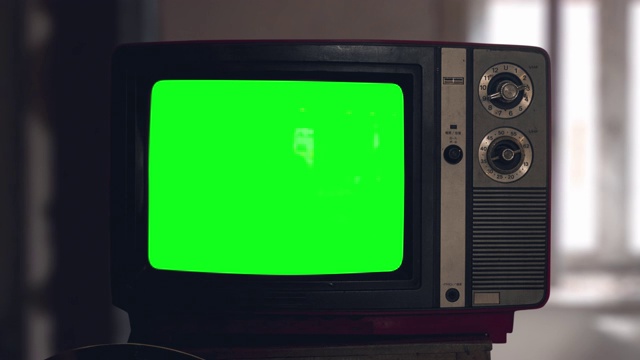 开关调谐一个旧管老式电视机比开关关闭。木制风格的复古电视与开关。老式电视开始播放。绿屏chromakey。反映在屏幕上视频素材