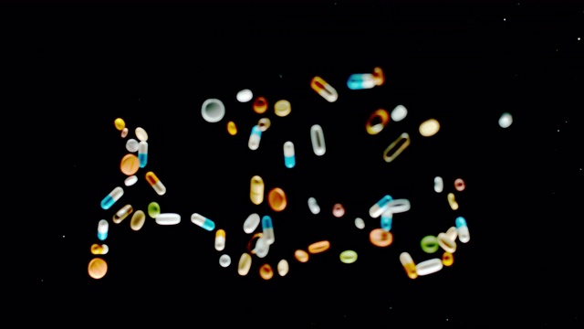 SLO MO LD“艾滋病”题字用五颜六色的药片、药丸和胶囊飞向空中视频素材
