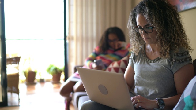 一个成熟女人用笔记本电脑在家工作的肖像视频素材