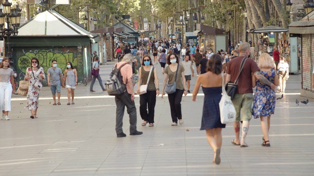 巴塞罗那兰布拉斯标志性街道上戴着面具的人们。2020年夏季冠状病毒危机视频下载