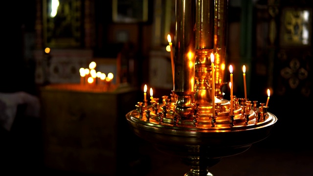 金色的大烛台与燃烧的蜡烛在一个模糊的背景视频素材
