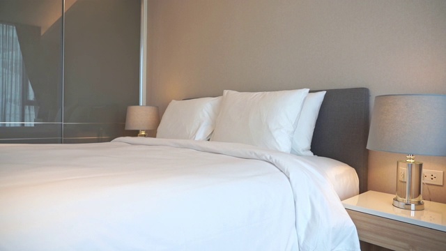 卧室室内的床上装饰舒适的白色枕毯视频下载