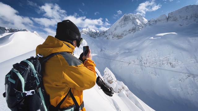 滑雪者在山顶用智能手机拍摄视频视频素材