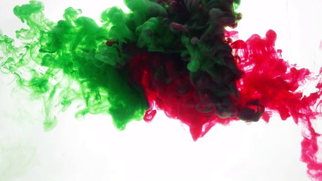 绿色和红色油墨混合在水在白色的背景视频素材