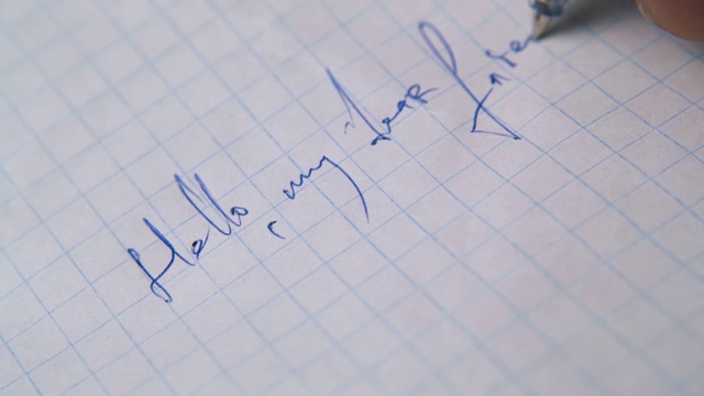 男人用蓝笔在格子纸上给朋友写信视频素材