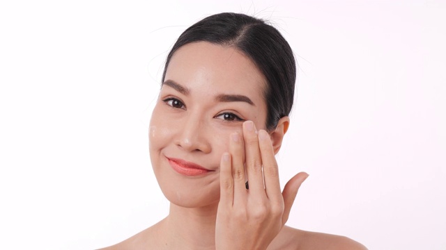 亚洲妇女的肖像与光滑的嘴唇在她的脸上涂霜。视频素材