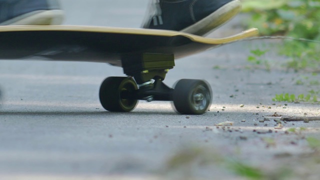 男子骑滑板在柏油路慢动作视频下载